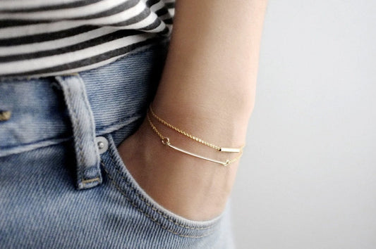 model with dainty gold bracelets set